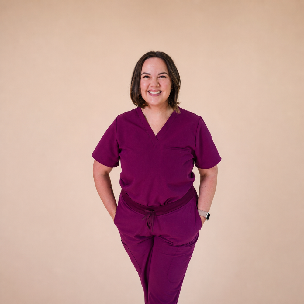Carrie Kim, IBCLC, smiling in medical scrubs